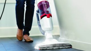 Bissell Vac & Steam cleaner in use on a tiled floor.