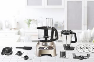 Tefal DoubleForce Pro food processor with accessories on countertop.